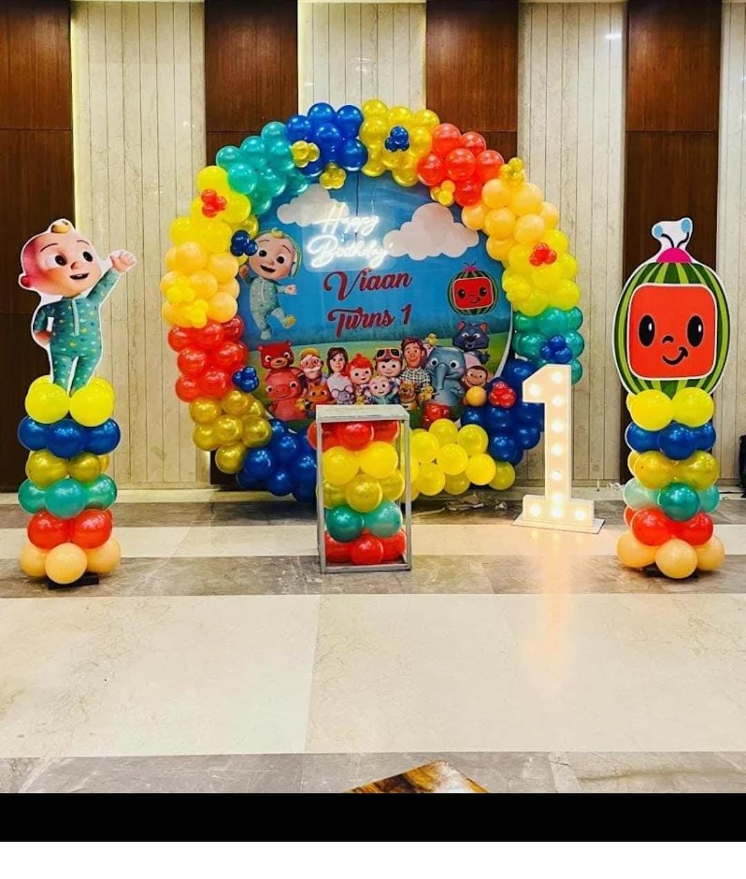 Cocomelon Rainbow First Birthday Stage balloon decoration setup in Delhi NCR